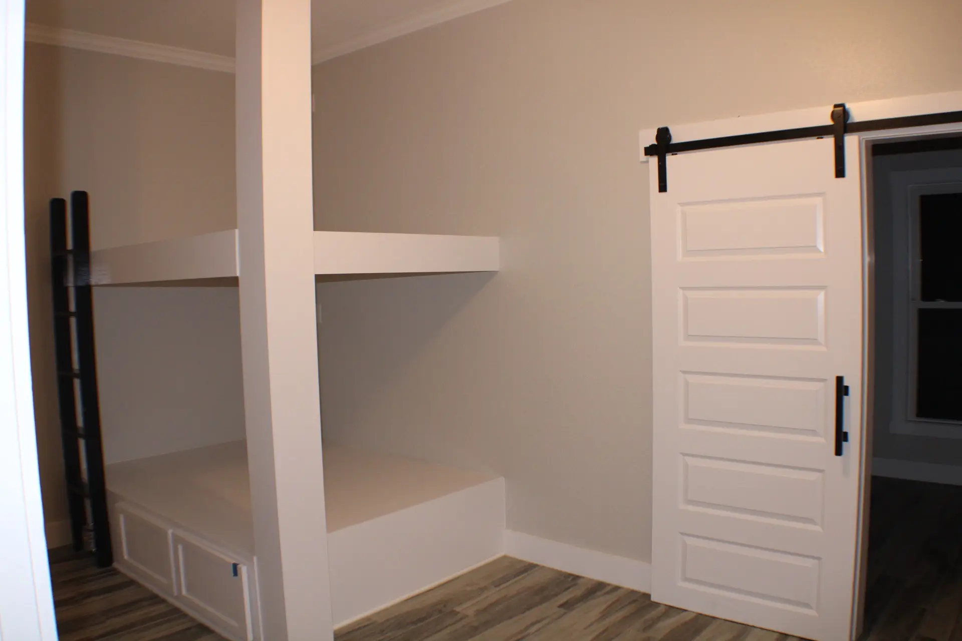 Glass-enclosed tub and shower combo with large-format gray stone tile surround, modern fixtures, and clean lines in the master bath