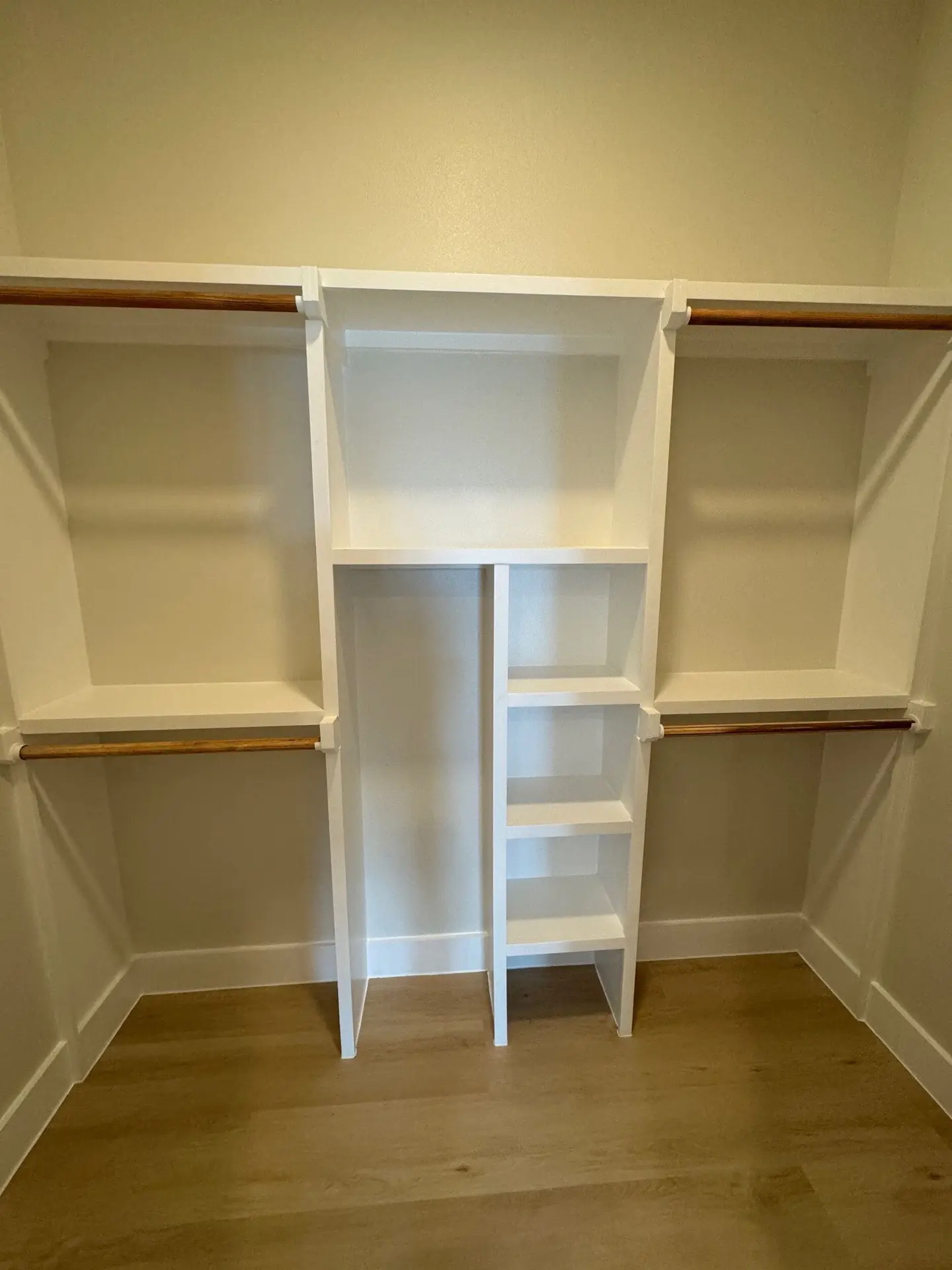 Kitchen viewed from the dining area with floor-to-ceiling cabinetry, gold hardware accents, and natural light from coastal windows