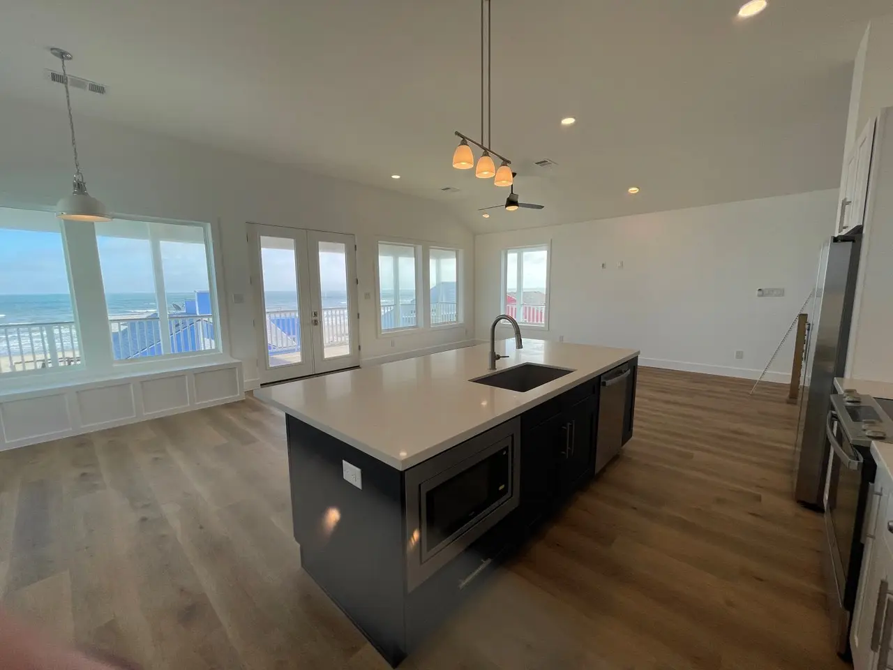 Staircase landing detail showing the transition from light oak treads to black metal railing with clean contemporary lines
