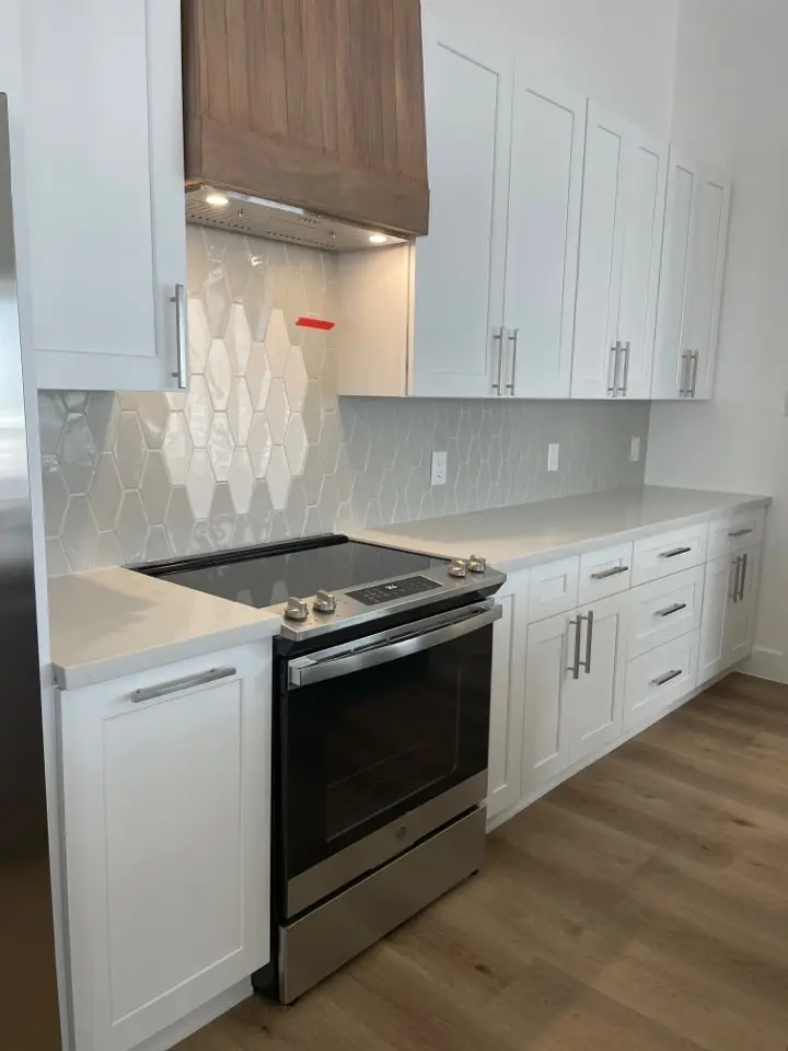 Built-in wine rack and open shelving flanking the kitchen window with Gulf views from the Galveston Island coastal home