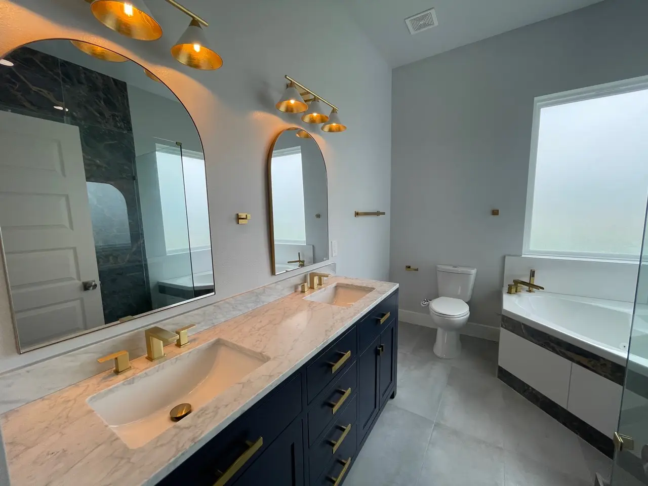 Mezzanine railing detail with sleek metal balusters and wood cap rail connecting the upper loft to the main level of the coastal home