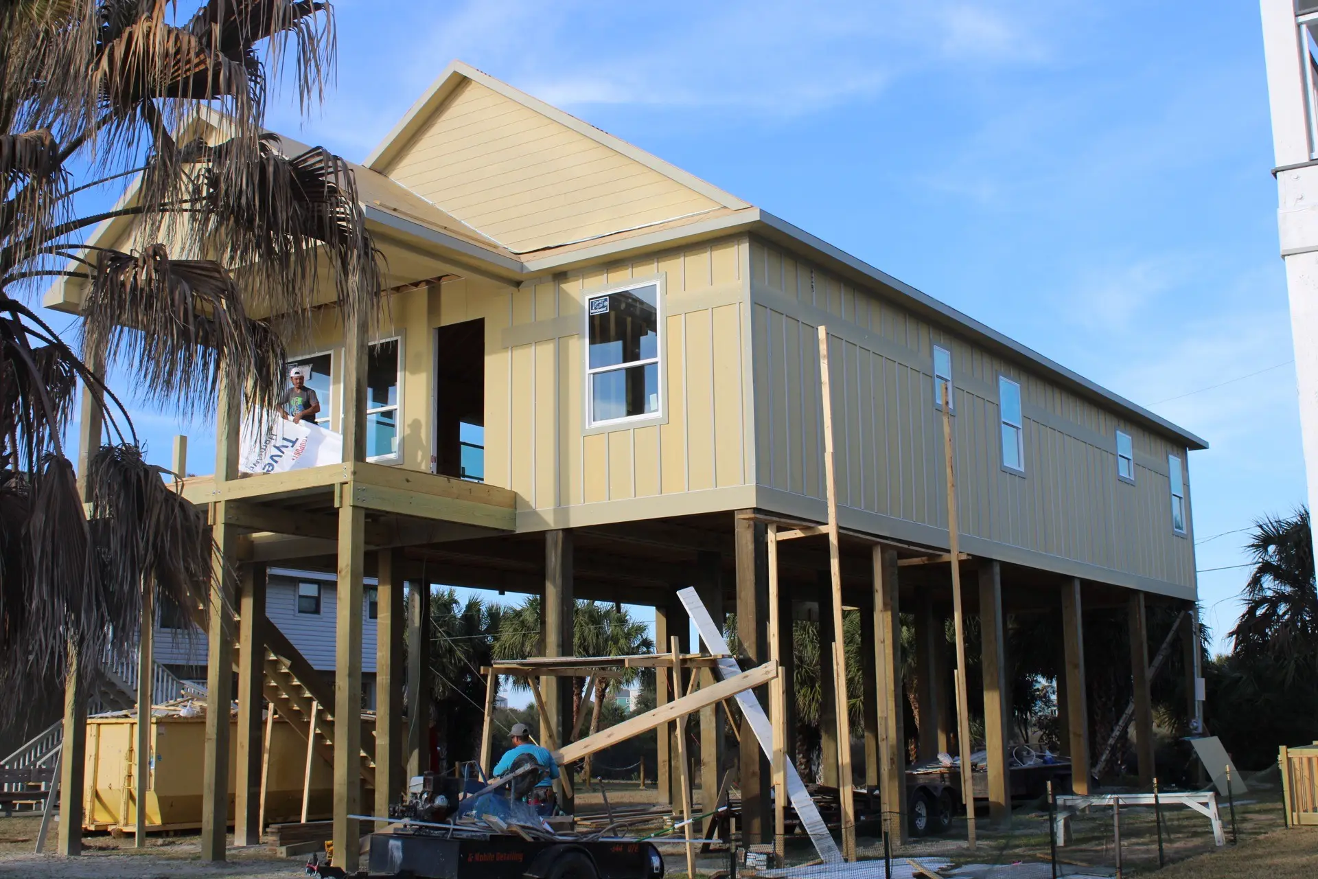 Master bedroom view toward the private covered deck through glass French doors with natural light flooding the room