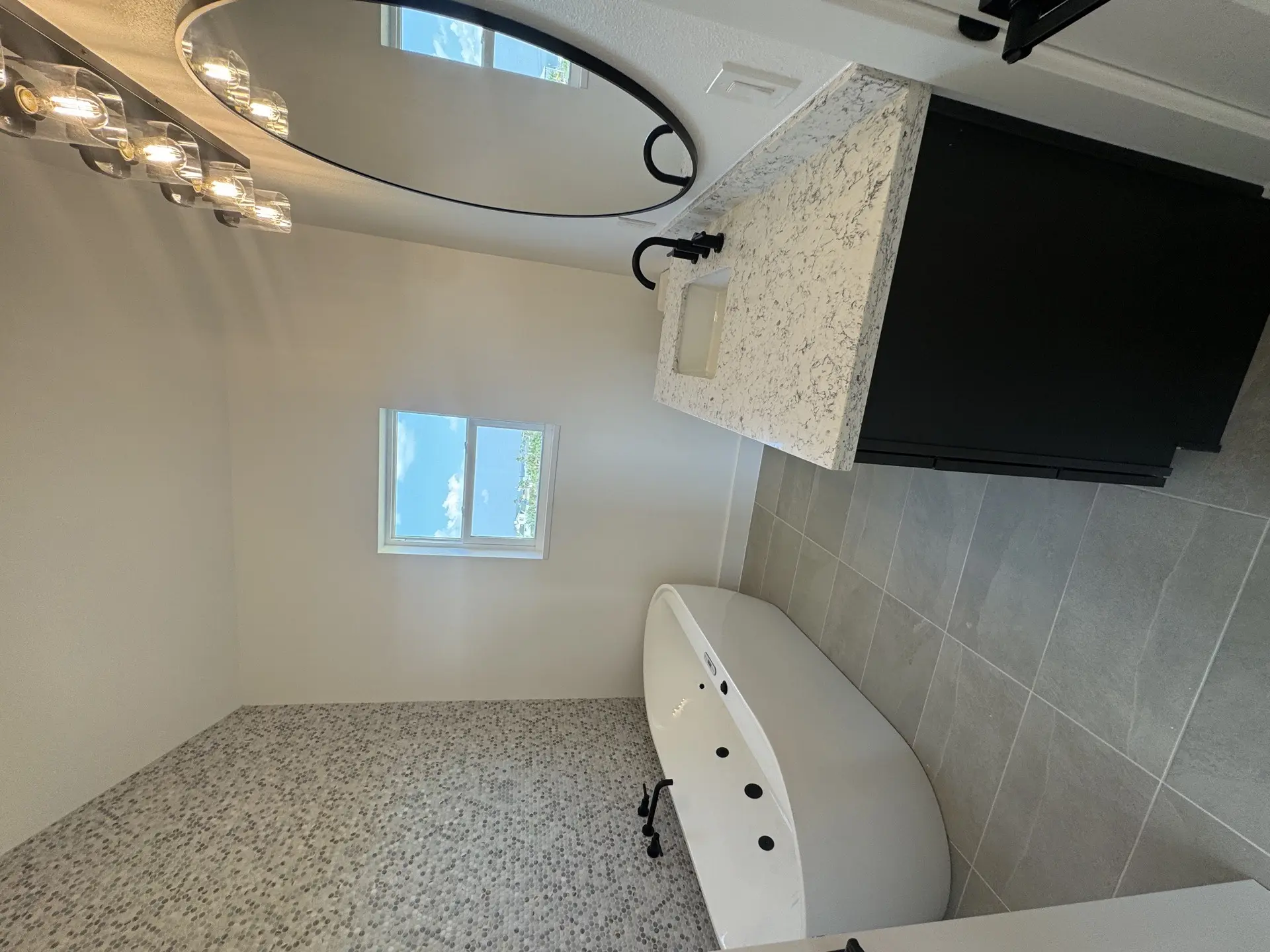 Guest half-bath with modern finishes and thoughtful design details maintaining the resort-quality standard throughout the Galveston beach house