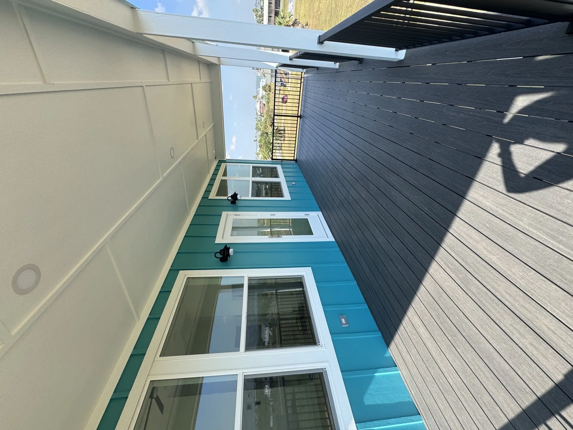 Third bedroom with clean lines, ample natural light, and the consistent high-ceiling design that runs throughout the Galveston beach home