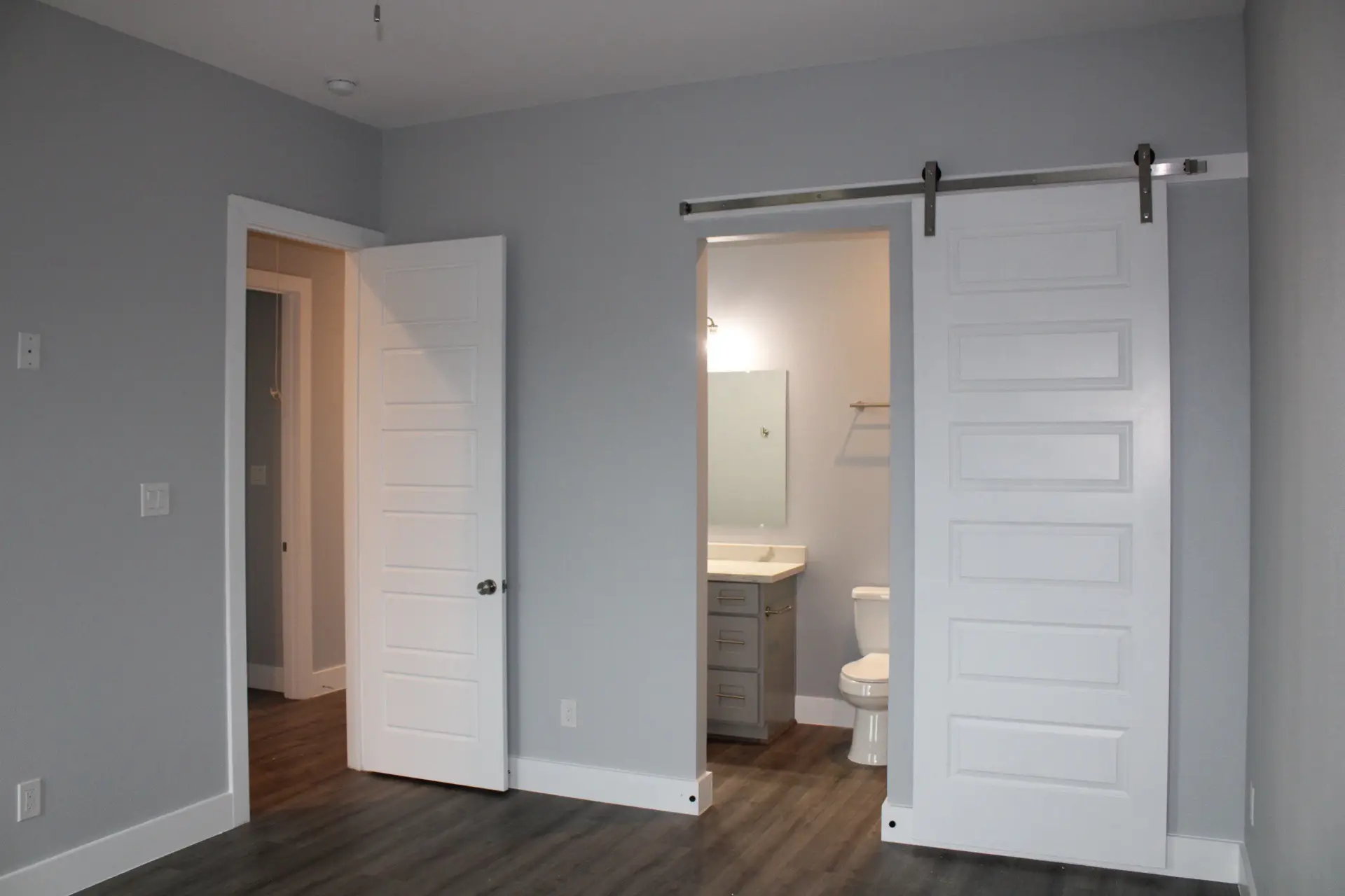 Covered porch detail showing white columns, composite decking, ceiling fan, and the inviting outdoor living space at 31 Laguna