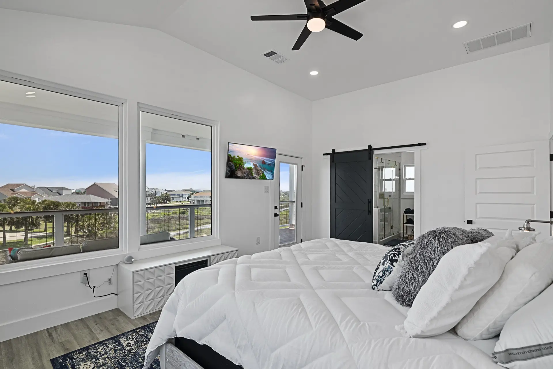 Dining area adjacent to the great room with modern chandelier, staged dining table, and waterfront views from the Tiki Island home