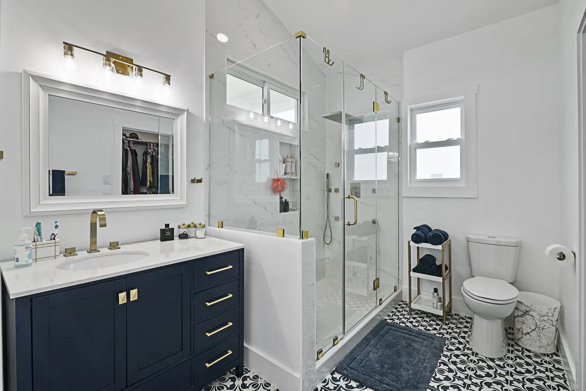 View from the living room toward the kitchen showing the seamless open floor plan, light flooring, and abundant natural light