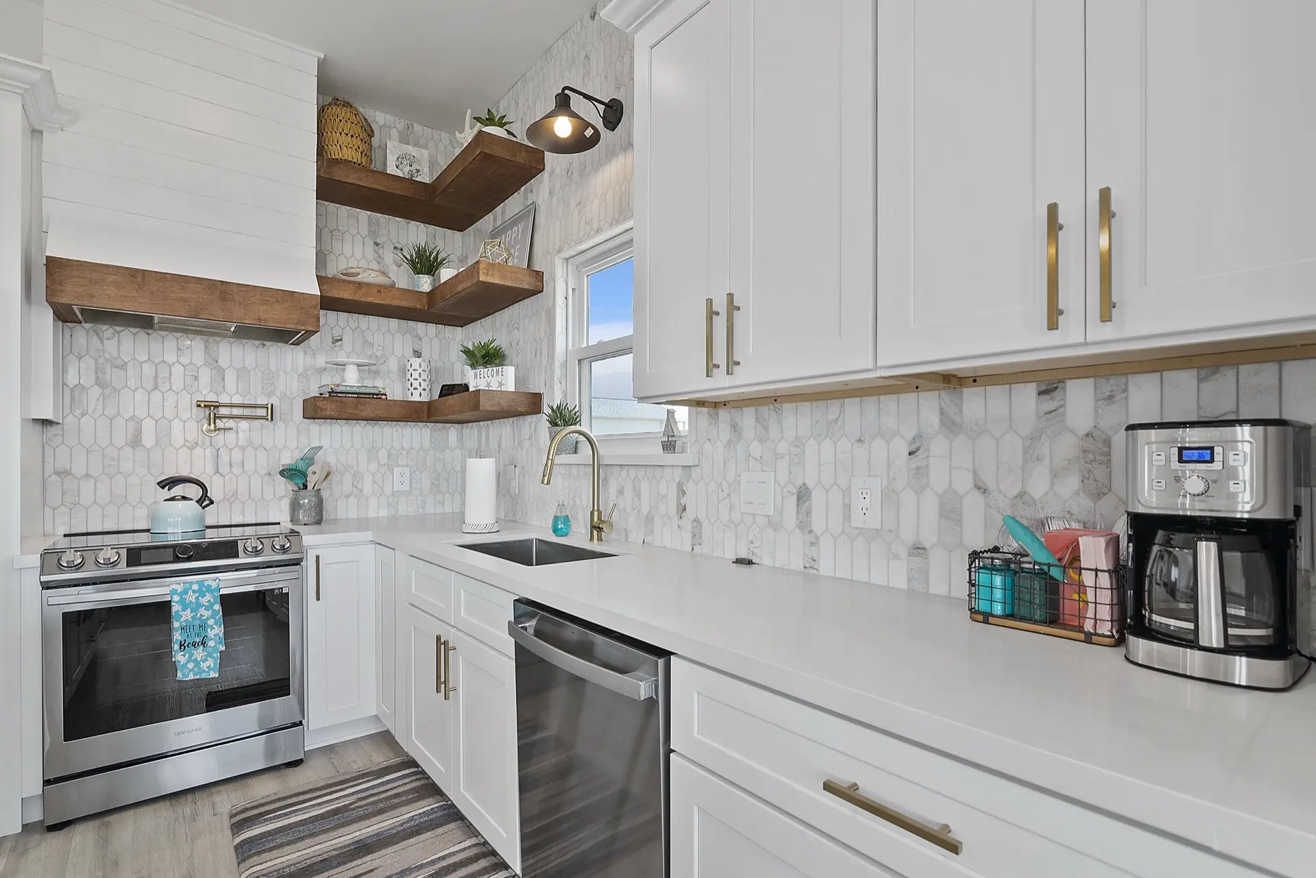 Master suite sitting area with water views through oversized windows and direct access to the covered balcony overlooking Tiki Island canal