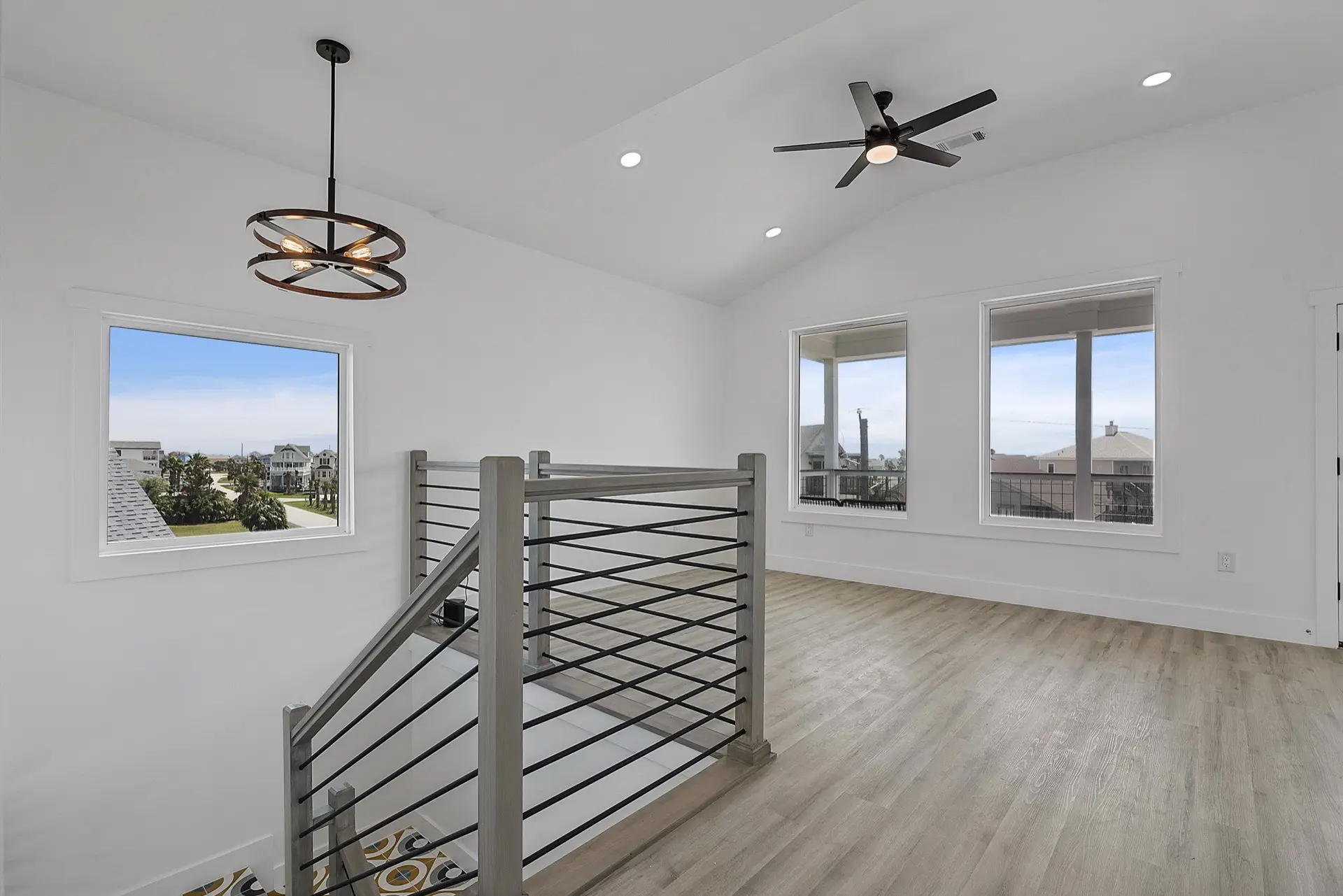Third guest bedroom configured with twin beds, coastal artwork, and light-toned finishes in the upscale modern coastal home
