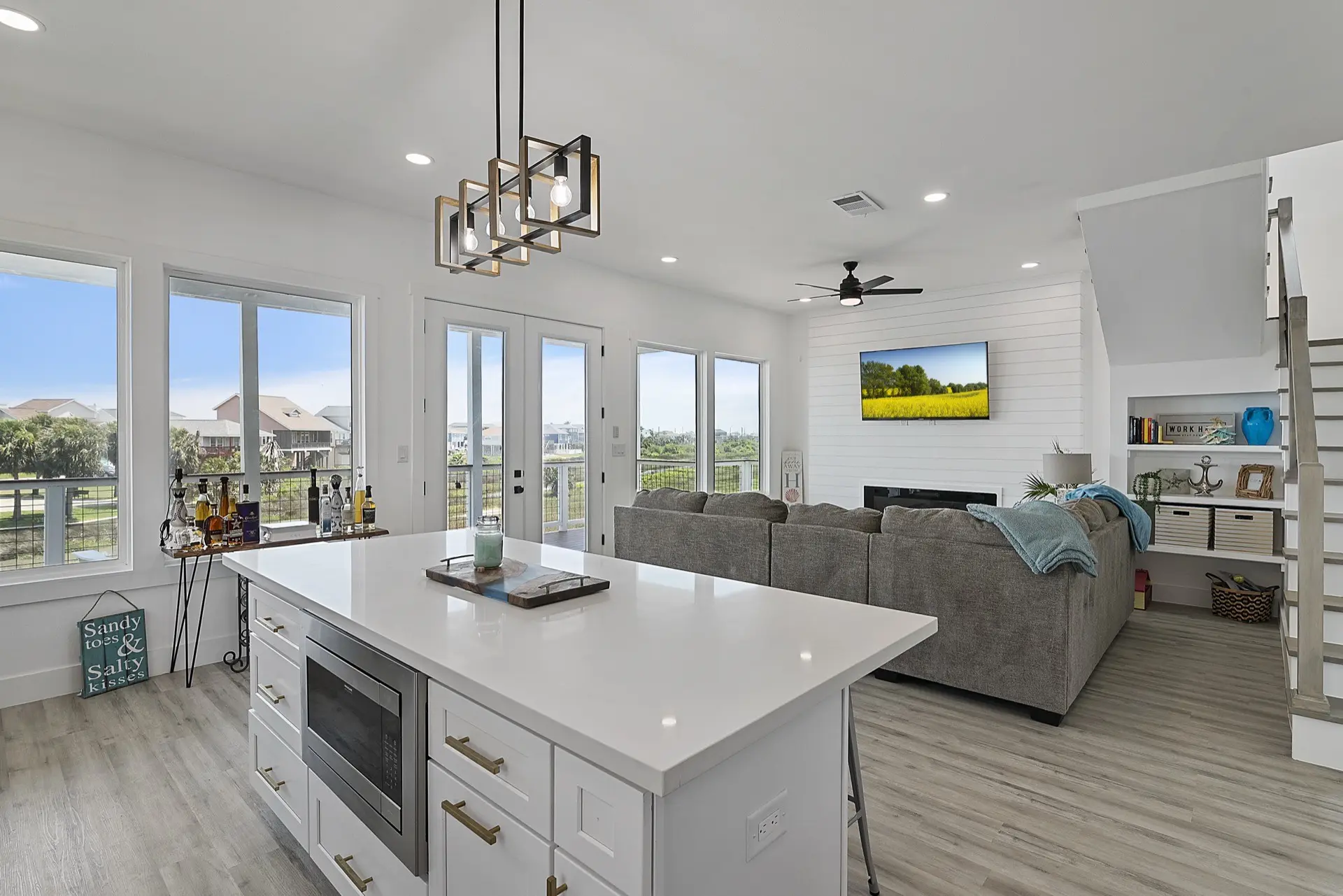 Sunset view from the 3742 Laguna covered deck looking out over the canal and Galveston marshland with warm golden light