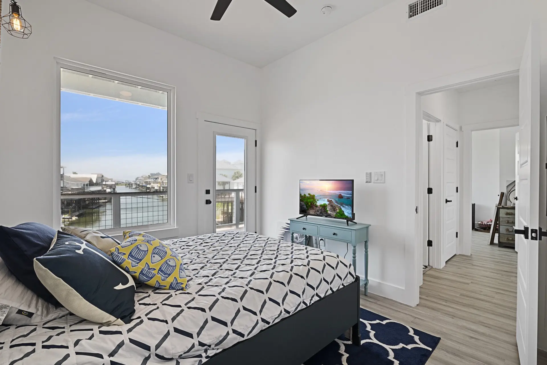 Hexagonal marble backsplash tile behind the stainless steel range with custom wood hood and gold accent hardware in the Tiki Island kitchen