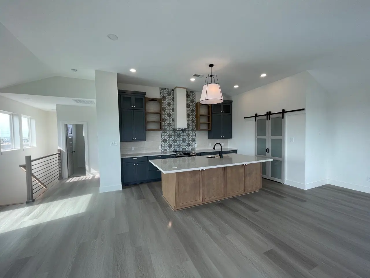 Custom built-in bunk room with four sleeping nooks, integrated stair access to upper bunks, individual reading lights, and light wood trim throughout