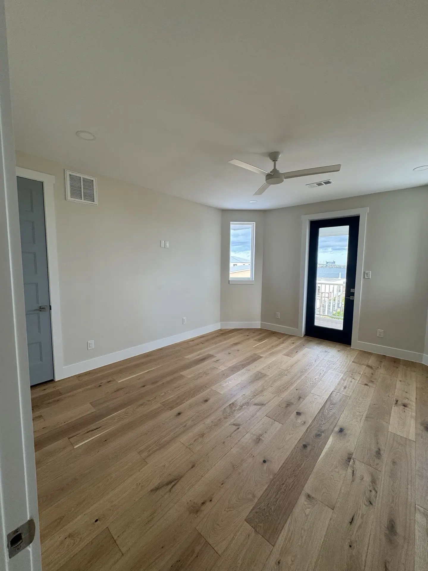 Reading nook or sitting area with built-in details, oak floors, and natural light from multiple windows in the West Bay Craftsman
