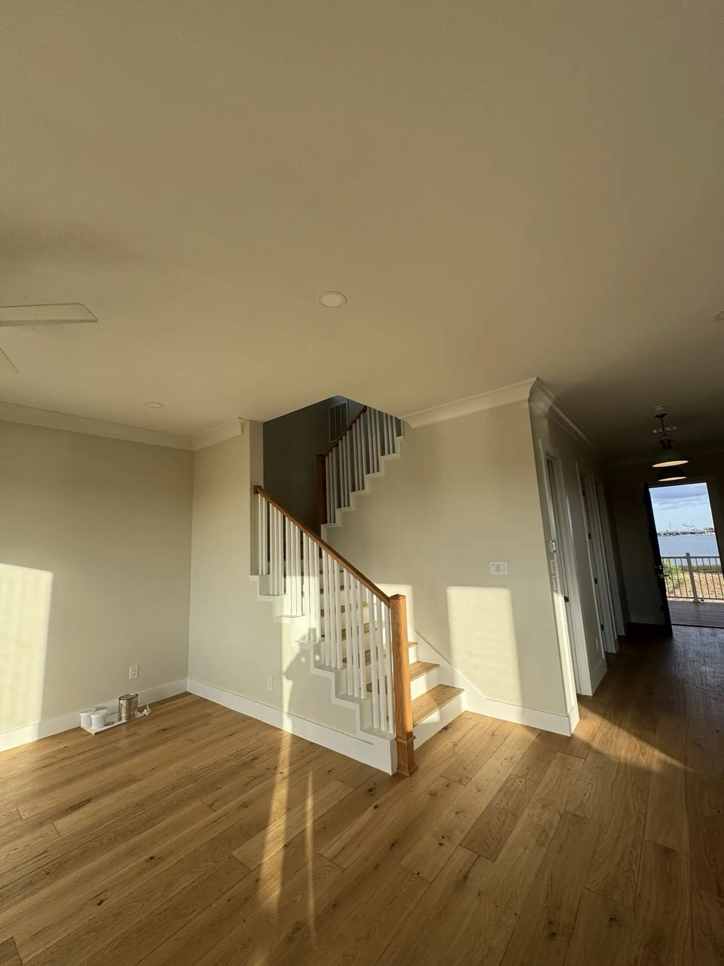 Upper balcony with sweeping panoramic views of West Bay, the causeway bridge, and marshland from the traditional coastal Craftsman home